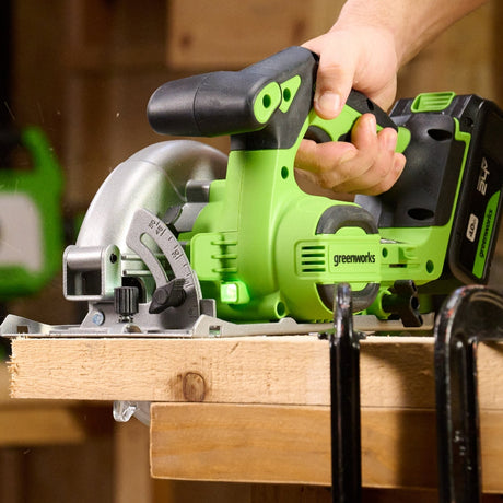 Greenworks cordless circular saw being used on a wooden surface